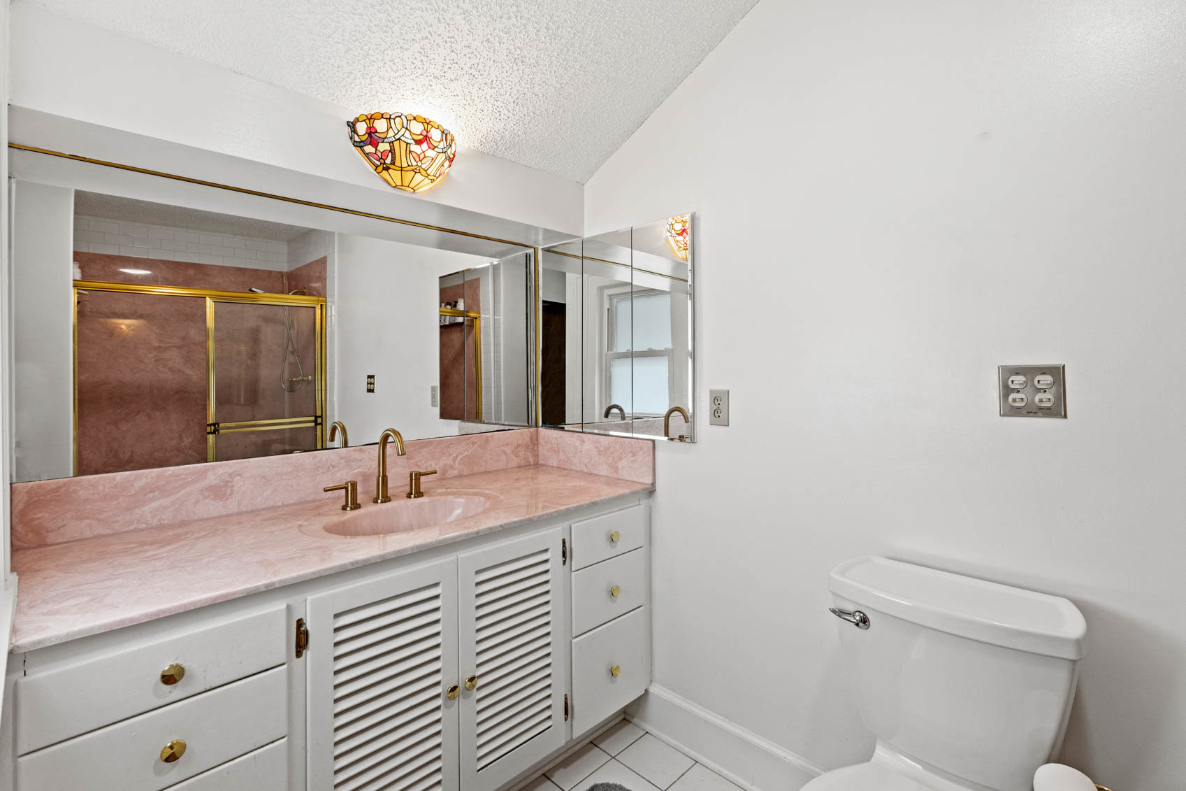 primary bathroom with sink cabinet and toilet